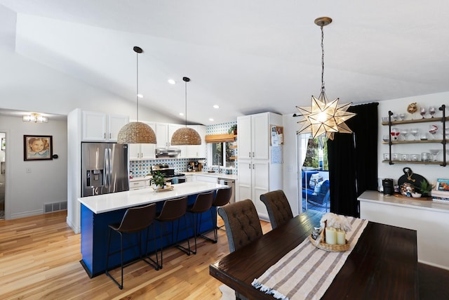 18017 N Lidgerwood Ct, Colbert, WA 99005 - dining space with vaulted ceiling, a chandelier, light wood-type flooring, and recessed lighting