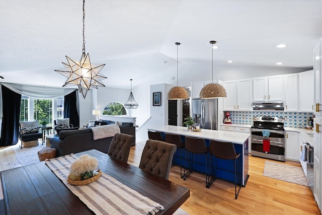 18017 N Lidgerwood Ct, Colbert, WA 99005 - dining room with light wood-style floors, vaulted ceiling, and a chandelier