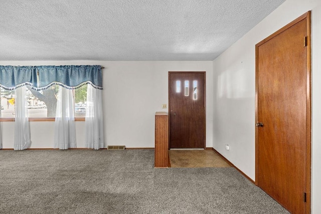 11622 E 24th Ave, Spokane Valley, WA 99206 - foyer featuring a textured ceiling and carpet floors