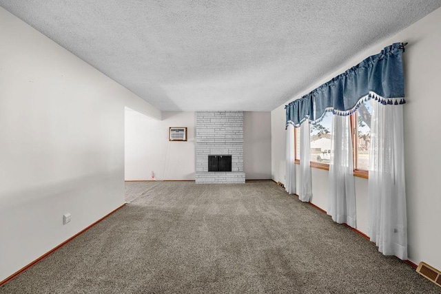 11622 E 24th Ave, Spokane Valley, WA 99206 - unfurnished living room with carpet floors, a textured ceiling, and a fireplace