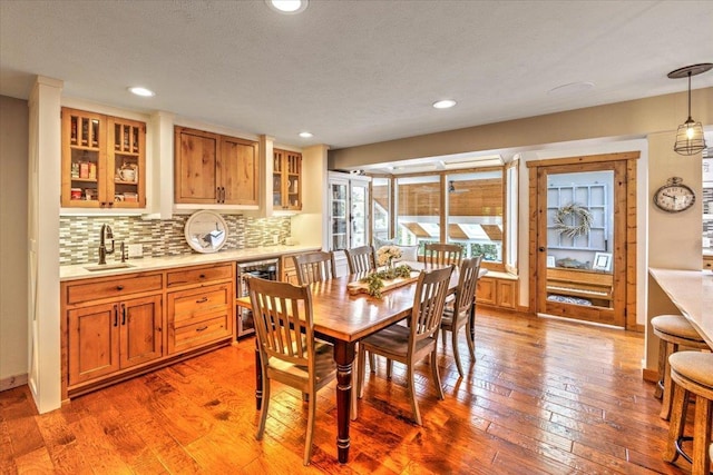 3222 S Conklin Rd, Greenacres, WA 99016 - dining space featuring light wood finished floors, bar with sink, recessed lighting, and wine cooler