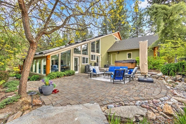 3222 S Conklin Rd, Greenacres, WA 99016 - rear view of property featuring a hot tub, a patio area, a sunroom, and an outdoor hangout area