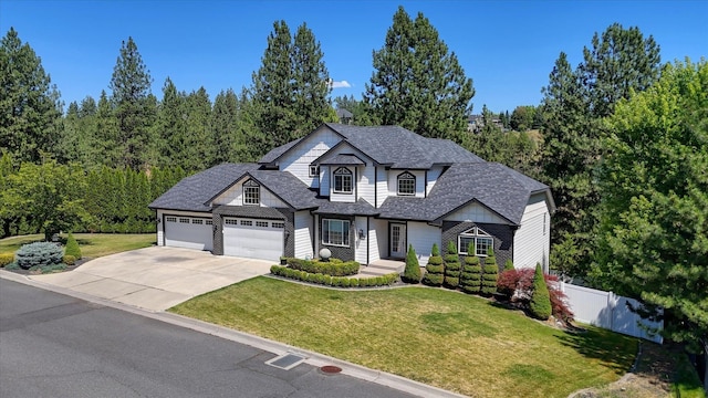 7302 N Quamish Dr, Spokane, WA 99208 - view of front facade with concrete driveway, an attached garage, and a shingled roof