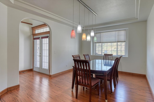 7302 N Quamish Dr, Spokane, WA 99208 - dining room with arched walkways, hardwood / wood-style floors, and a raised ceiling
