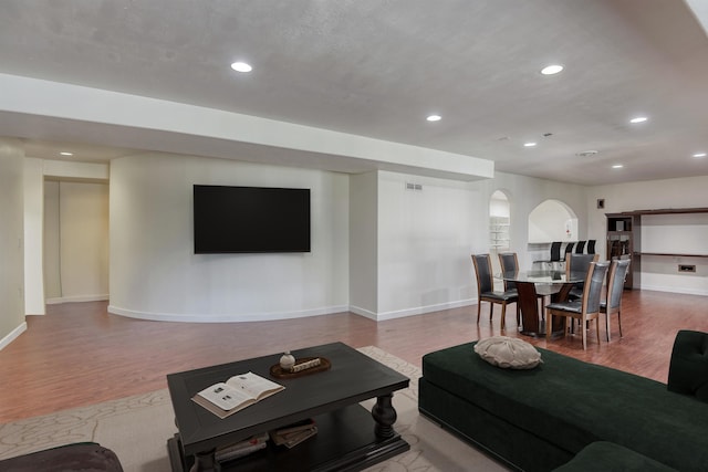 7302 N Quamish Dr, Spokane, WA 99208 - living room with arched walkways, wood finished floors, and recessed lighting