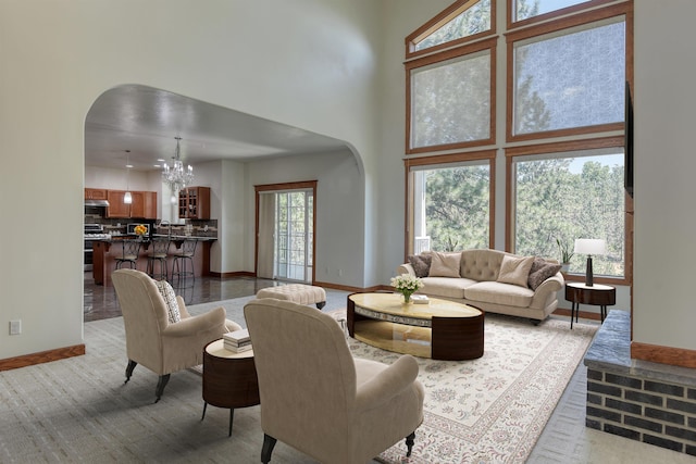 7302 N Quamish Dr, Spokane, WA 99208 - living room featuring arched walkways, a chandelier, and a high ceiling