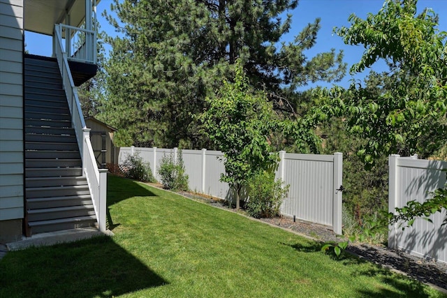 7302 N Quamish Dr, Spokane, WA 99208 - fenced backyard featuring a storage unit, a balcony, and stairs