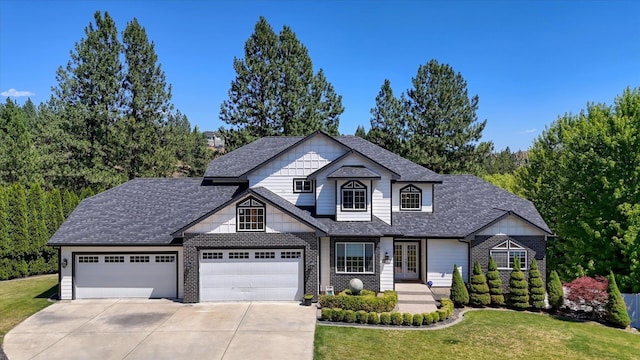 7302 N Quamish Dr, Spokane, WA 99208 - view of front of home featuring driveway, a front yard, french doors, and a shingled roof