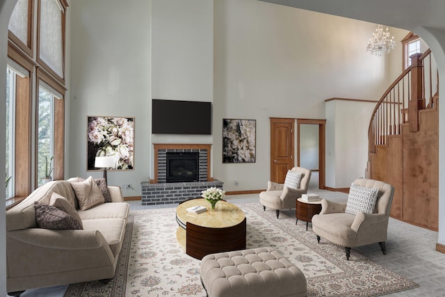 7302 N Quamish Dr, Spokane, WA 99208 - living room with a towering ceiling, healthy amount of natural light, a chandelier, a brick fireplace, and stairs