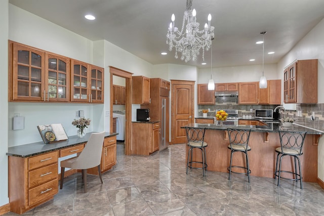 7302 N Quamish Dr, Spokane, WA 99208 - kitchen featuring appliances with stainless steel finishes, brown cabinetry, decorative backsplash, glass insert cabinets, and a breakfast bar area