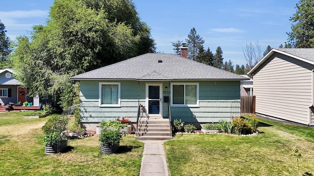 3526 W Hoffman Ave, Spokane, WA 99205 - bungalow featuring a shingled roof, a chimney, and a front yard