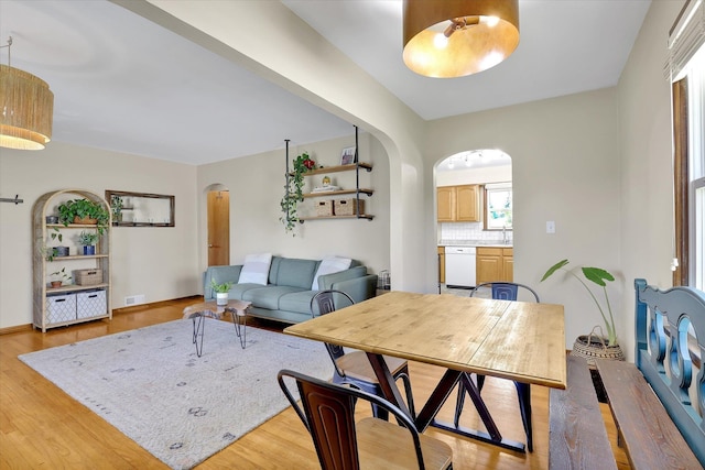 3526 W Hoffman Ave, Spokane, WA 99205 - living area with arched walkways and light wood-style flooring