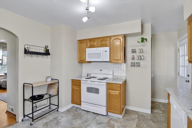 3526 W Hoffman Ave, Spokane, WA 99205 - kitchen with white appliances, arched walkways, tasteful backsplash, and light stone counters