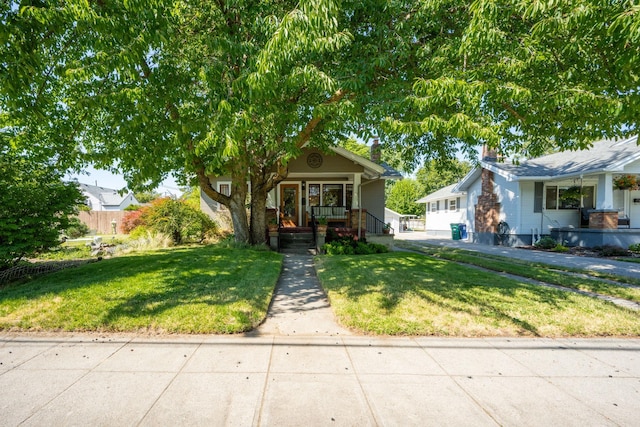 617 E 34th Ave, Spokane, WA 99203 - view of front of home with covered porch and a front yard