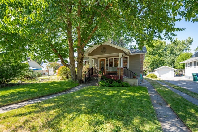 617 E 34th Ave, Spokane, WA 99203 - bungalow with an outbuilding, a detached garage, a porch, a front lawn, and a chimney