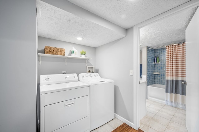 617 E 34th Ave, Spokane, WA 99203 - laundry area featuring washing machine and clothes dryer, a textured ceiling, and light tile patterned floors