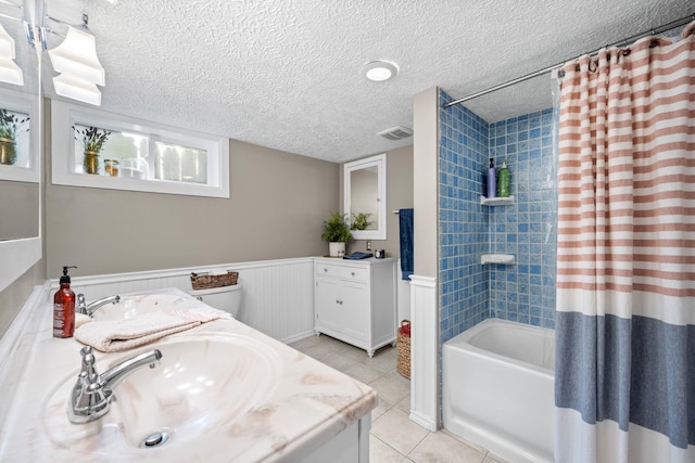 617 E 34th Ave, Spokane, WA 99203 - bathroom featuring tile patterned floors, double vanity, shower / bathtub combination with curtain, wainscoting, and a textured ceiling