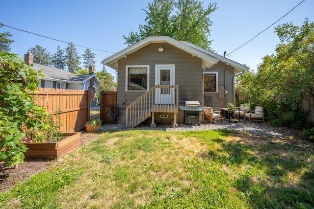 617 E 34th Ave, Spokane, WA 99203 - rear view of house with a vegetable garden and outdoor lounge area