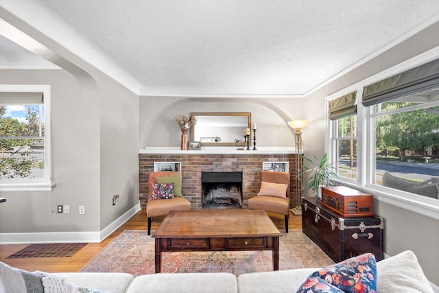 617 E 34th Ave, Spokane, WA 99203 - living area with a fireplace, wood finished floors, and crown molding