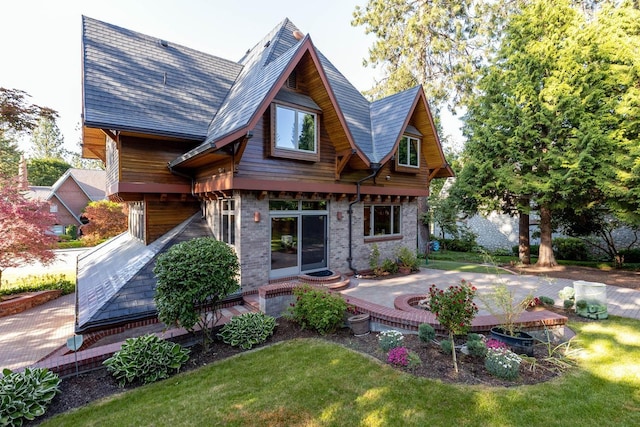 2010 E Pinecrest Rd, Spokane, WA 99203 - back of house featuring a patio, a lawn, and brick siding