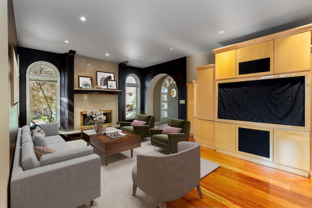2010 E Pinecrest Rd, Spokane, WA 99203 - living area featuring a large fireplace, arched walkways, light wood-style floors, and recessed lighting
