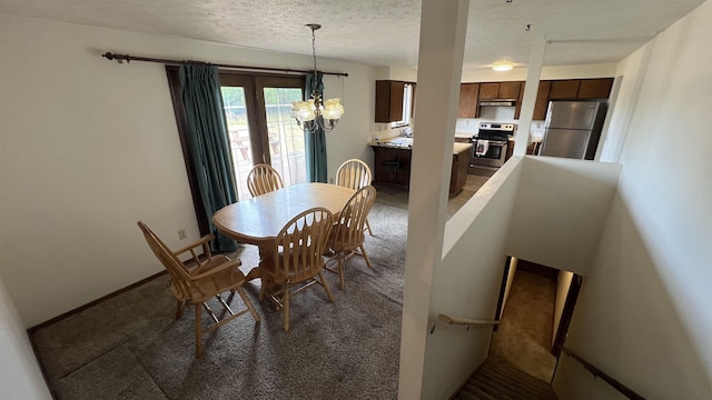 3520 N Arden Rd, Otis Orchards, WA 99027 - carpeted dining room featuring a chandelier and a textured ceiling