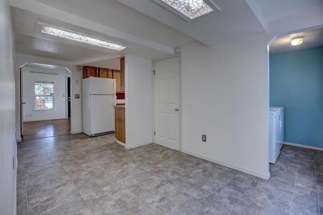 3222 W 4th Ave, Spokane, WA 99224 - unfurnished living room featuring arched walkways, washer and dryer, and stone finish flooring