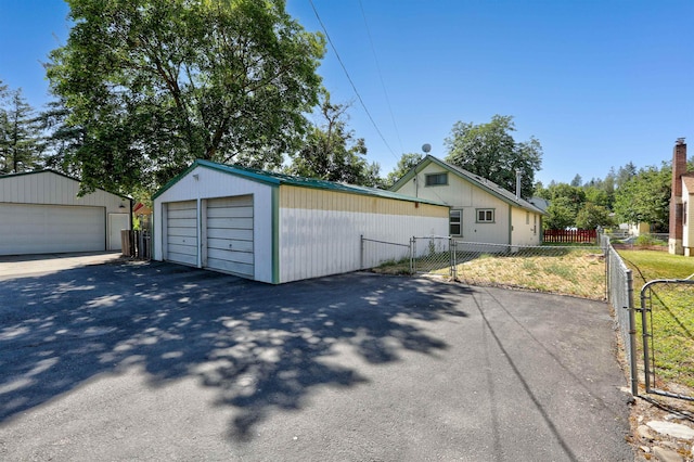 3222 W 4th Ave, Spokane, WA 99224 - view of front of house with a detached garage, an outdoor structure, and a gate