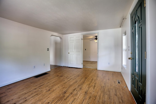 3222 W 4th Ave, Spokane, WA 99224 - unfurnished room with arched walkways, wood finished floors, and a ceiling fan