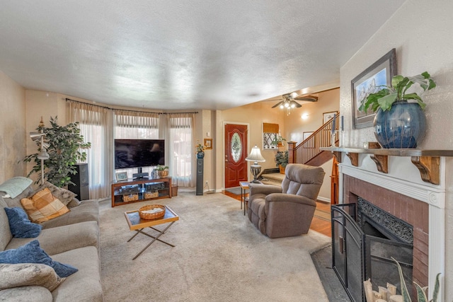 814 E Montgomery Ave, Spokane, WA 99207 - living area featuring a fireplace, stairway, a ceiling fan, and a textured ceiling