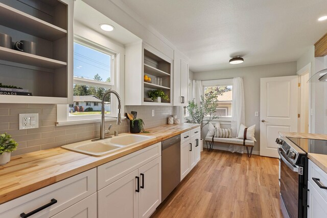 4017 E Pratt Ave, Spokane, WA 99204 - kitchen featuring butcher block counters, open shelves, appliances with stainless steel finishes, white cabinets, and light wood-style floors