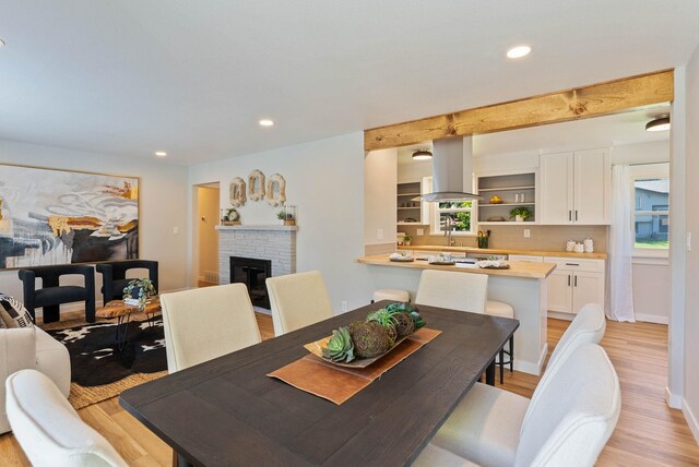 4017 E Pratt Ave, Spokane, WA 99204 - dining room featuring light wood-style flooring, recessed lighting, and a brick fireplace