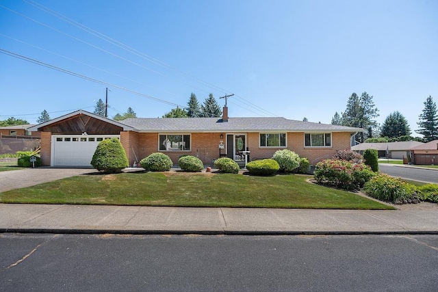 4335 W Excell Ave, Spokane, WA 99208 - ranch-style home featuring concrete driveway, a front yard, a chimney, a garage, and brick siding