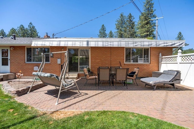 4335 W Excell Ave, Spokane, WA 99208 - rear view of house with a patio, brick siding, a chimney, and entry steps