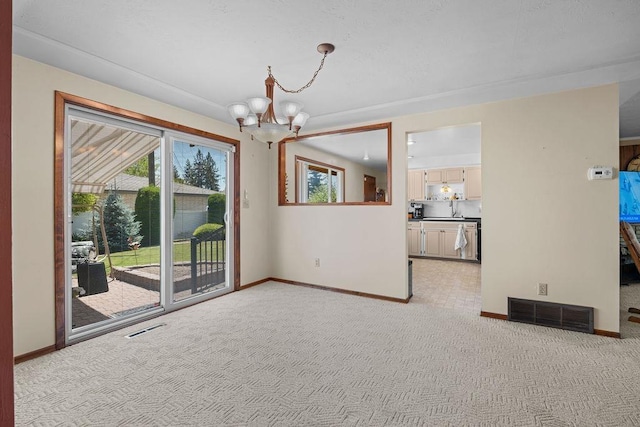 4335 W Excell Ave, Spokane, WA 99208 - empty room with a chandelier and light colored carpet