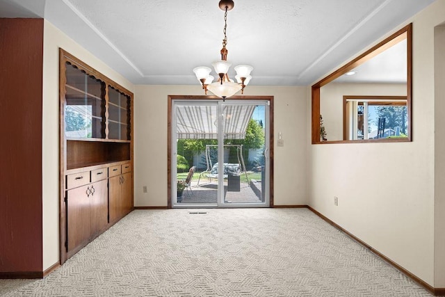 4335 W Excell Ave, Spokane, WA 99208 - unfurnished dining area featuring a chandelier and light carpet