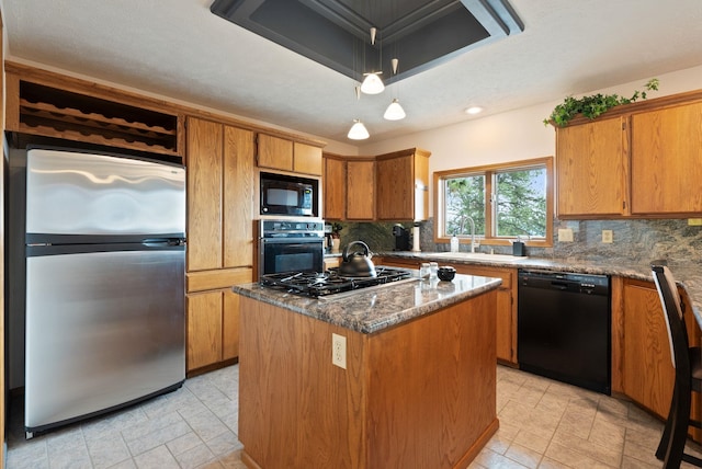3314 W Eagles Nest Ln, Spokane, WA 99208 - kitchen with black appliances, backsplash, brown cabinetry, a center island, and recessed lighting