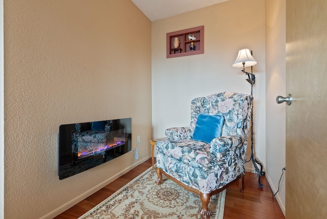 3314 W Eagles Nest Ln, Spokane, WA 99208 - sitting room with wood finished floors and a glass covered fireplace