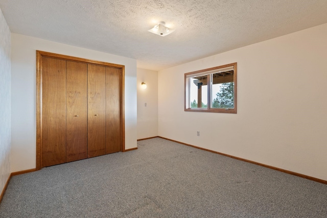 3314 W Eagles Nest Ln, Spokane, WA 99208 - unfurnished bedroom featuring carpet, a closet, and a textured ceiling