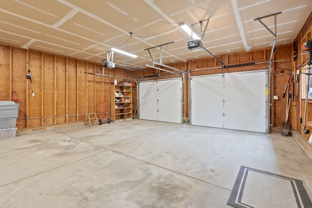 3314 W Eagles Nest Ln, Spokane, WA 99208 - garage featuring a garage door opener and wood walls