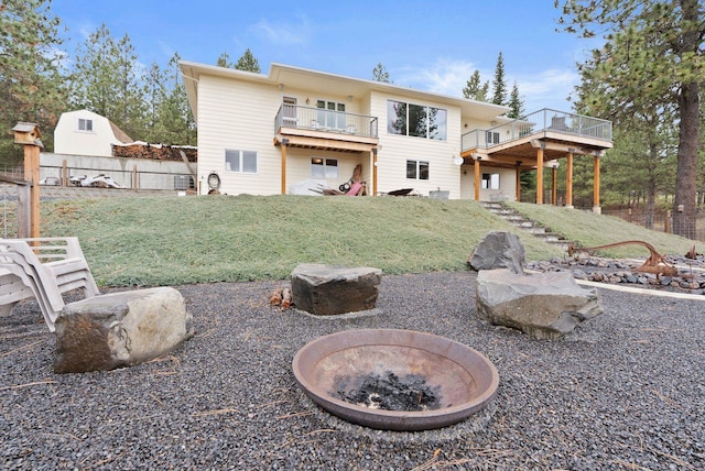 3314 W Eagles Nest Ln, Spokane, WA 99208 - back of property featuring an outdoor fire pit and a wooden deck
