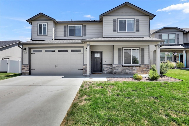 1119 S Soda Rd, Spokane, WA 99224 - view of front facade with stone siding, driveway, an attached garage, a porch, and a shingled roof