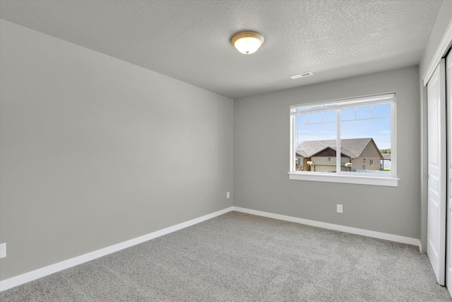 1119 S Soda Rd, Spokane, WA 99224 - spare room featuring carpet flooring and a textured ceiling