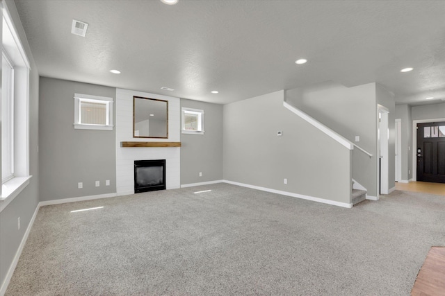 1119 S Soda Rd, Spokane, WA 99224 - unfurnished living room with a fireplace, recessed lighting, carpet flooring, and stairs