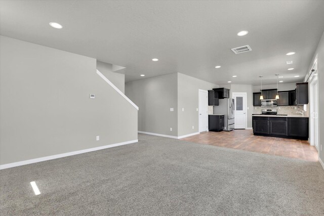 1119 S Soda Rd, Spokane, WA 99224 - unfurnished living room featuring light colored carpet and recessed lighting
