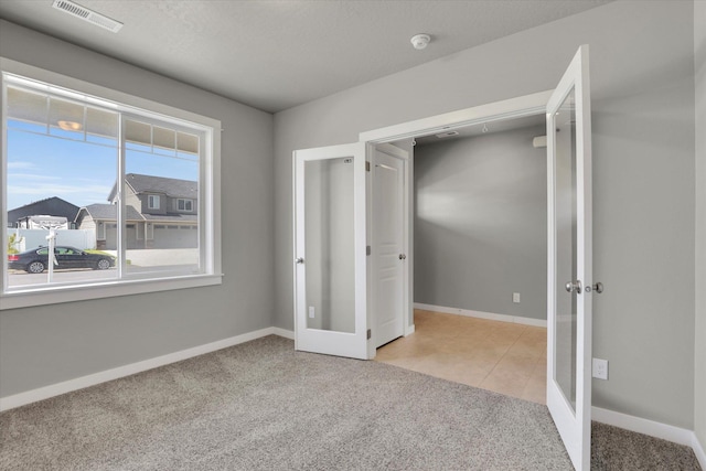 1119 S Soda Rd, Spokane, WA 99224 - unfurnished bedroom featuring french doors and carpet floors