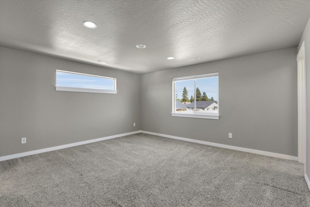 1119 S Soda Rd, Spokane, WA 99224 - unfurnished room featuring healthy amount of natural light, carpet flooring, a textured ceiling, and recessed lighting