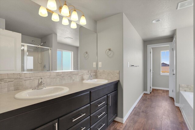 1119 S Soda Rd, Spokane, WA 99224 - full bath with a stall shower, decorative backsplash, double vanity, a bath, and a textured ceiling