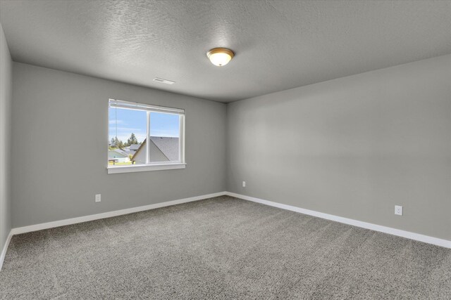 1119 S Soda Rd, Spokane, WA 99224 - carpeted empty room with baseboards and a textured ceiling