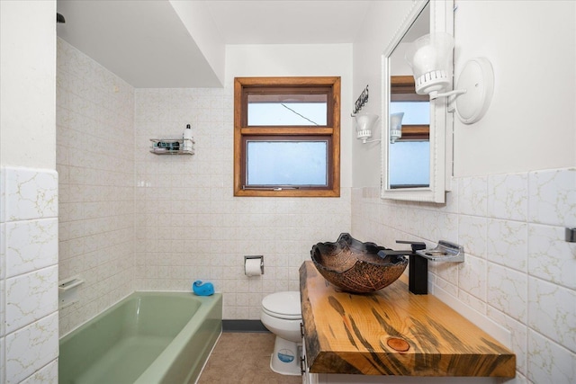7616 E Baldwin Ave, Spokane, WA 99212 - bathroom with tile walls, a tub, vanity, wainscoting, and a shower